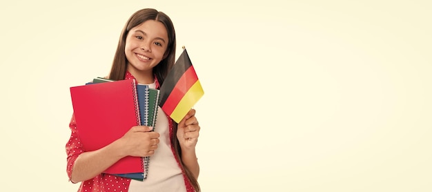 Happy kid hold german flag and school copybook for studying isolated on white foreign language Banner of school girl student Schoolgirl pupil portrait with copy space