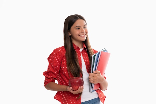 Happy kid hold school copybook for studying and apple lunch isolated on white childhood