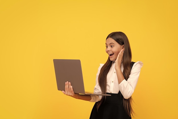 Happy kid in school uniform study on laptop online education