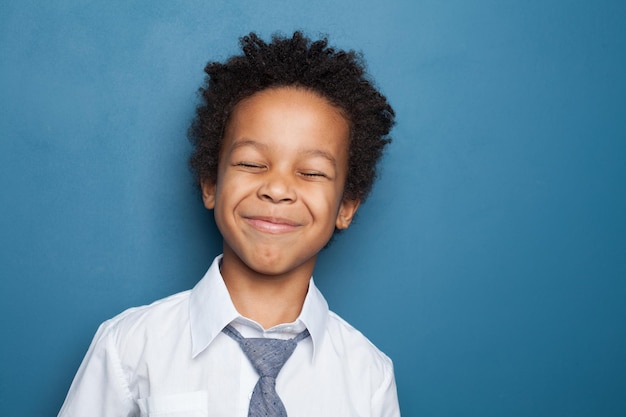 Happy kid smiling on blue background