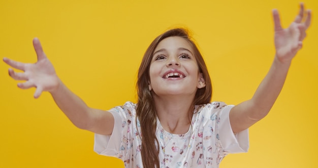 Happy kid smiling on yellow background