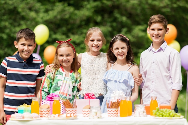 happy kids on birthday party at summer garden