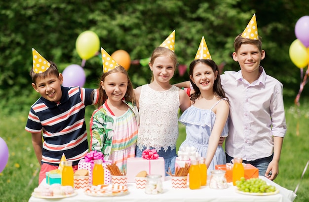 happy kids on birthday party at summer garden