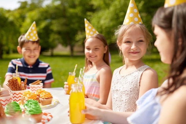 happy kids on birthday party at summer garden