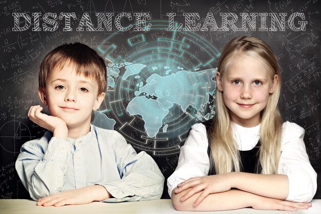 Happy kids and distance learning Smart school girl and boy on blackboard background with world map