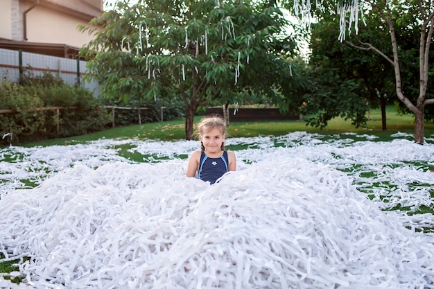 Happy kids enjoy paper show on backyard outdoor birthday party celebration in the garden