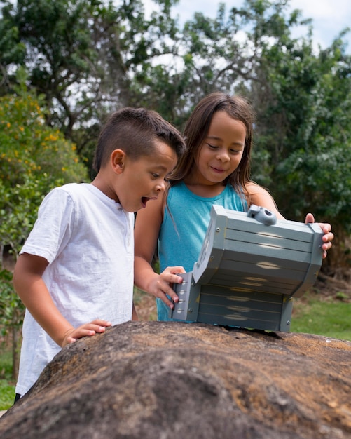 Happy kids finding the treasure in a treasure hunt