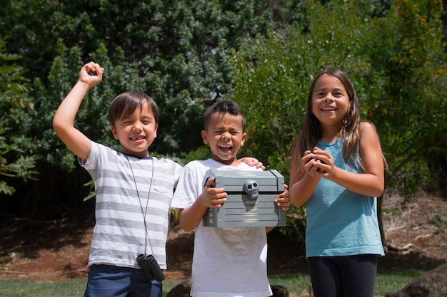 Happy kids finding the treasure in a treasure hunt