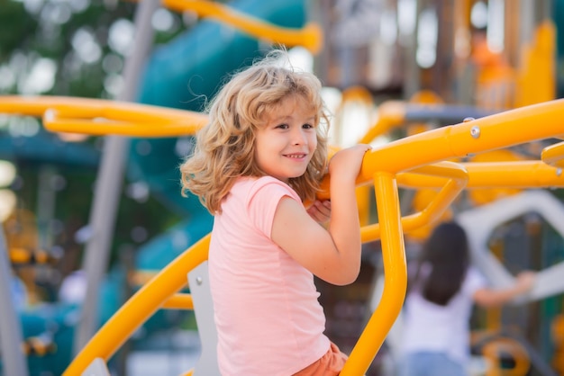 Happy kids having fun on playground adorable little child boy having fun on playground