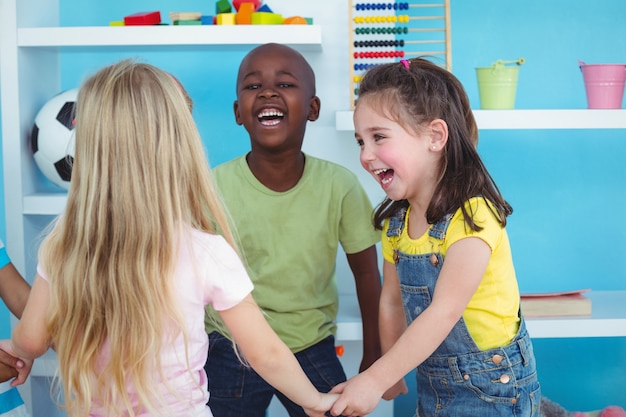 Happy kids holding hands together