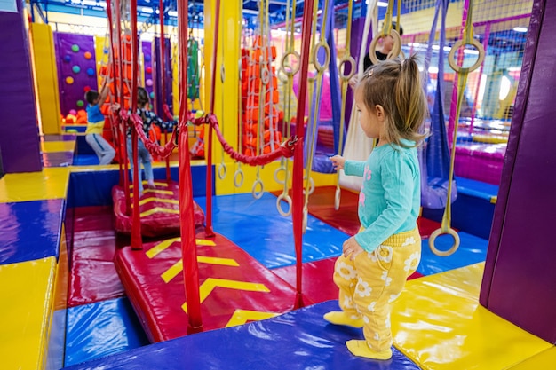 Happy kids playing at indoor play center playground