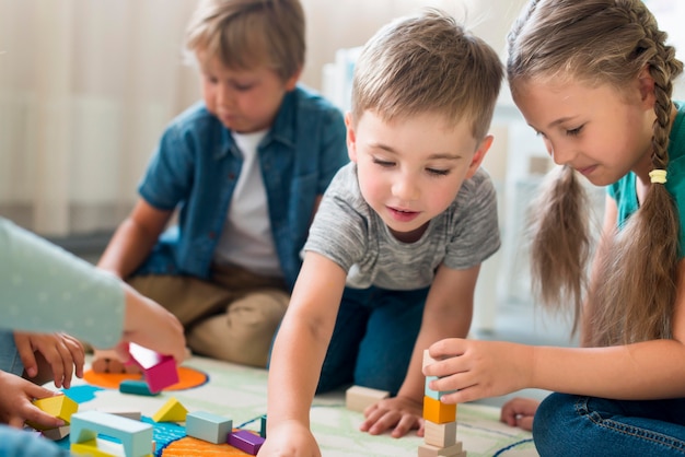 happy kids playing together in kindergarten