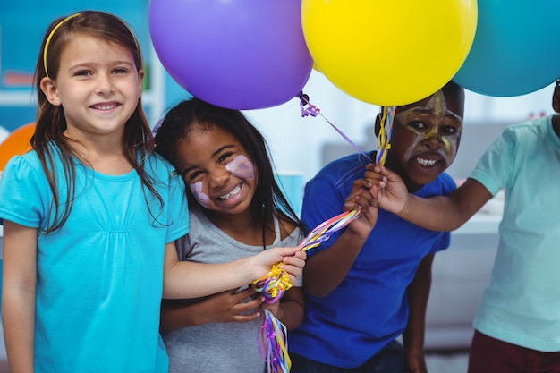 Happy kids playing with balloons