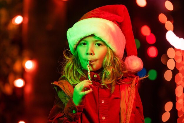 Happy kids portrait child enjoying winter holiday in the front yard house decorated with garlands ch