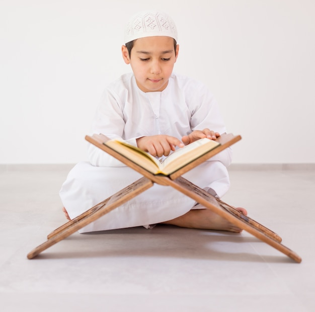 Happy kids reading Koran