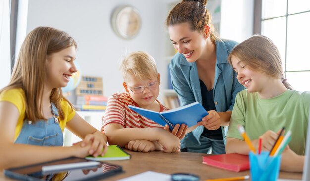 Happy kids and teacher at school