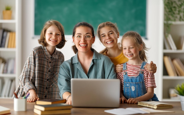 Happy kids and teacher at school