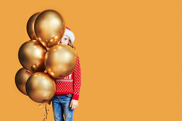 Happy kids with Christmas presents and balloons