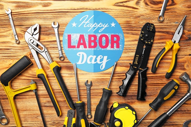 Photo happy labor day holiday and tools set on wooden background