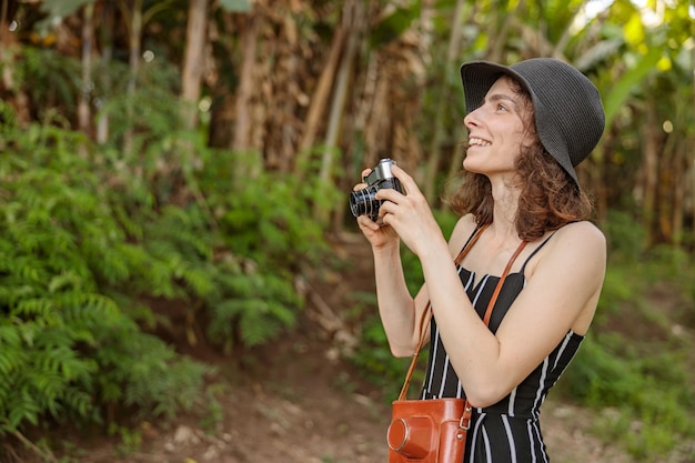 Happy lady making photo while traveling through Africa