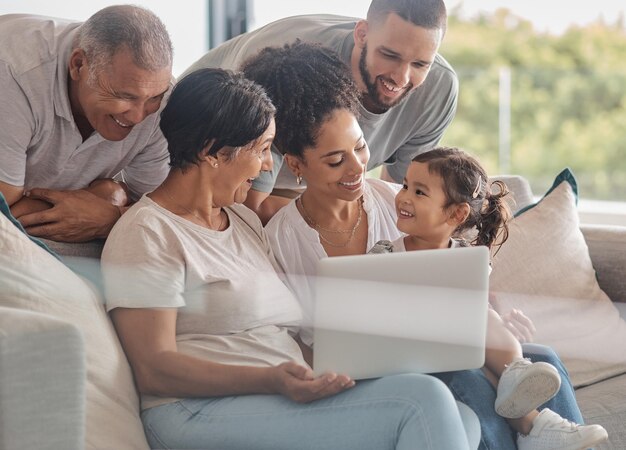 Happy Laptop And Big Family Streaming A Movie Relaxing And Bonding Together On The Weekend At Home Child Grandparents And Mother With Father Watching Movies On Online Entertainment Subscription