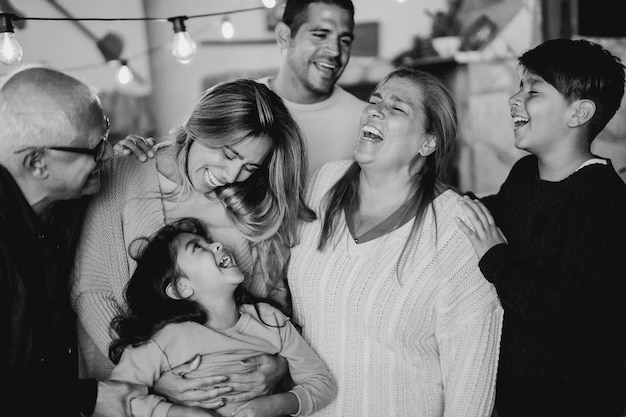 Happy latin family having fun and hugging each other at home patio