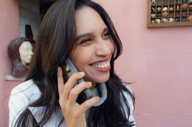 happy latin woman on the phone