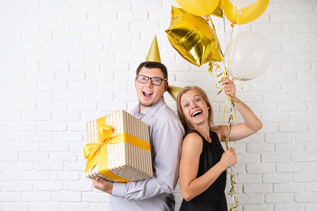 Happy laughing couple celebrating birthday party