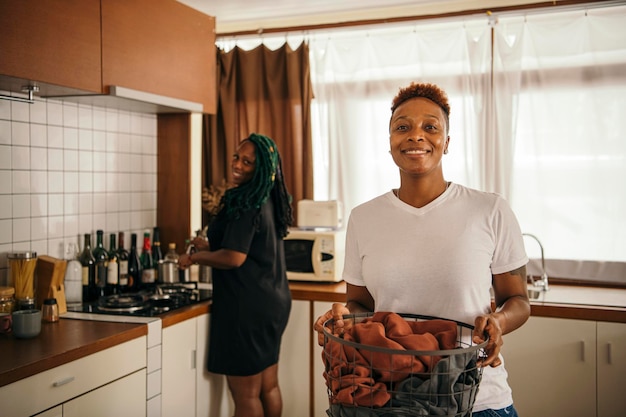 Happy lesbian couple doing house chores