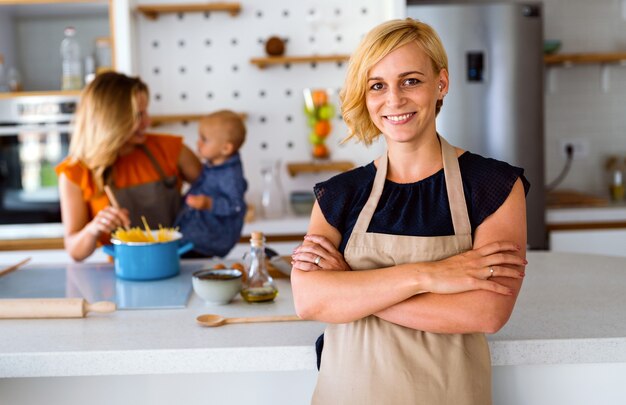 Happy lesbian female couple with her little child at home. Family, kid, fun concept