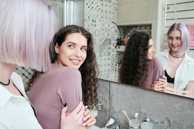 Happy lesbians in bathroom