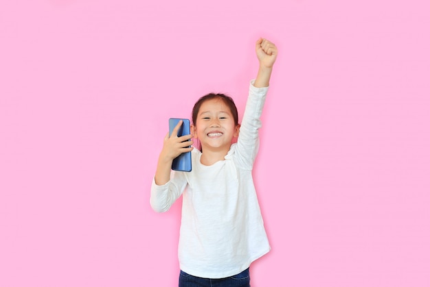 Happy little asian girl on pink background