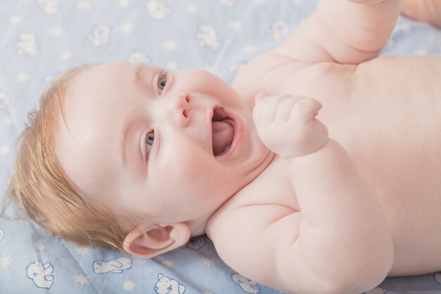 Happy little baby on bed