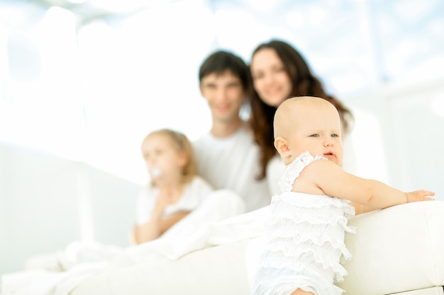 Happy little baby on blurred background of the family.photo with copy space