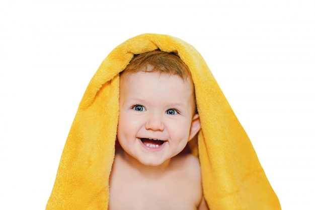 Happy little baby in yellow towel.