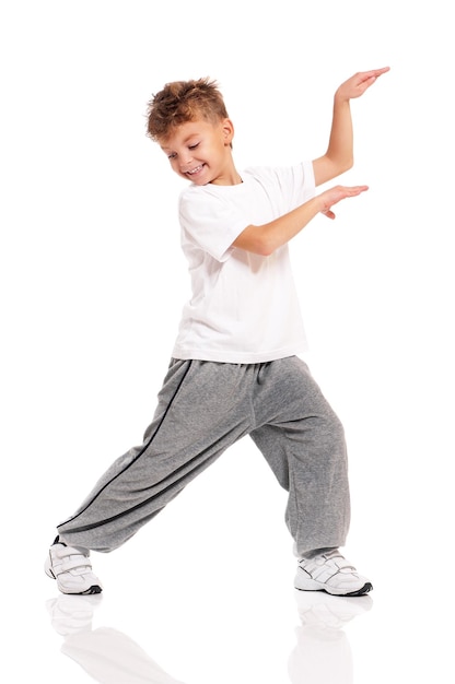Photo happy little boy dancing isolated on white background