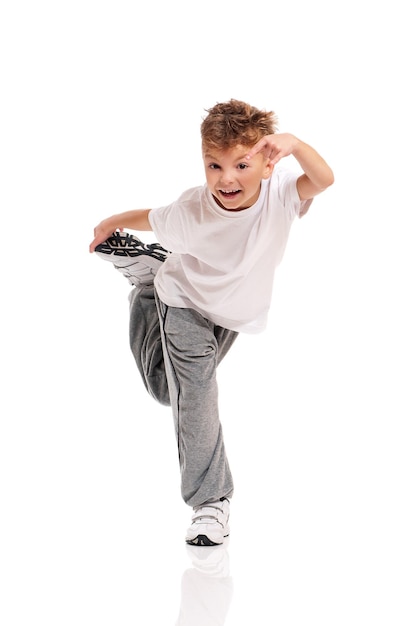 Happy little boy dancing isolated on white background