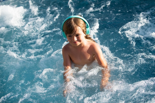 Happy little boy having fun in summer swimming pool family vacation