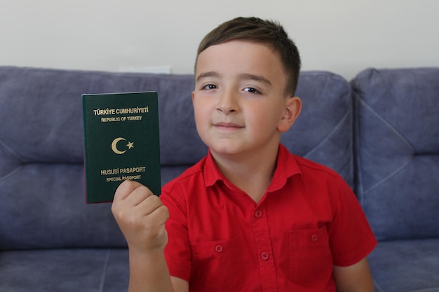 happy little boy holding turkish passport