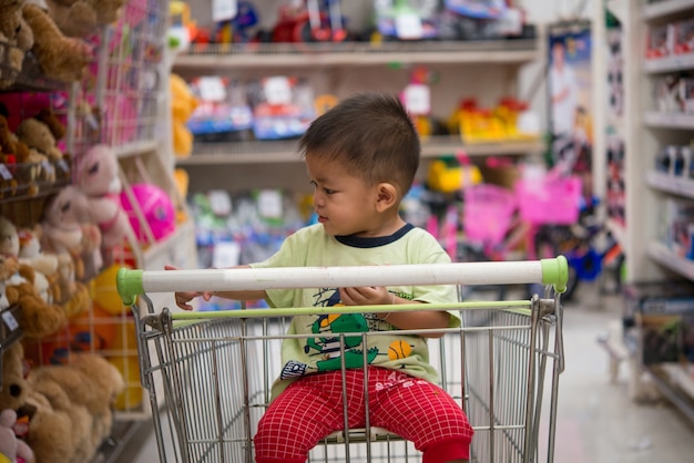 Happy little boy in the supper market