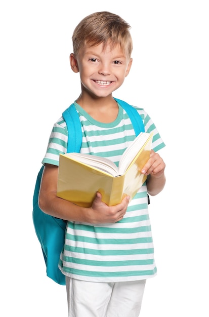 Happy little boy with book isolated on white background