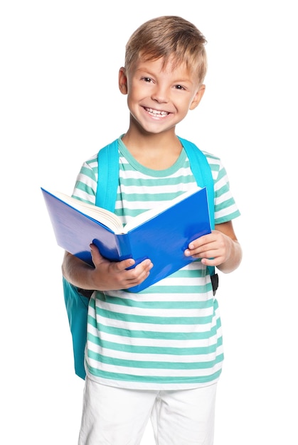 Happy little boy with book isolated on white background