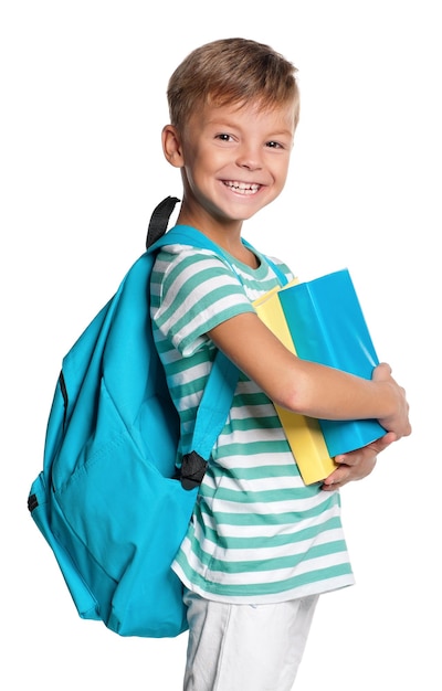 Happy little boy with books isolated on white background