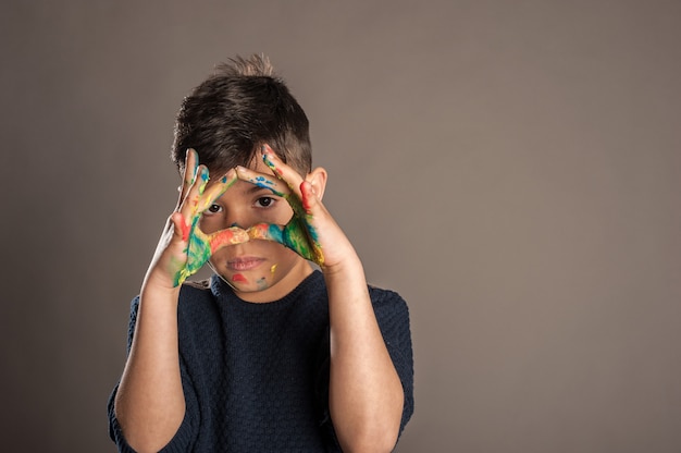 Happy little boy with his hands painted 