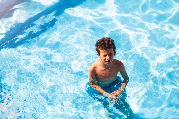 Happy little boys enjoying relaxing and splashing in the water