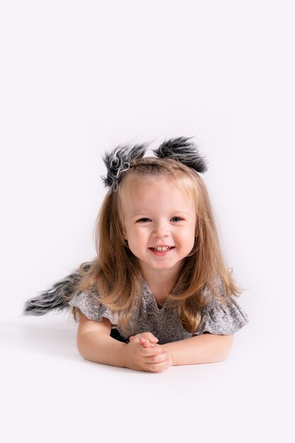 Happy little funny emotional child girl in cute Christmas wolf costume on white