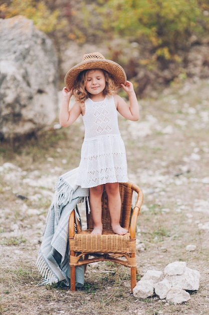 happy little girl in a chair outdoors