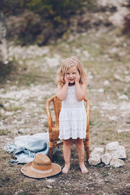 happy little girl in a chair outdoors