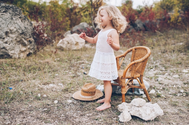 happy little girl in a chair outdoors