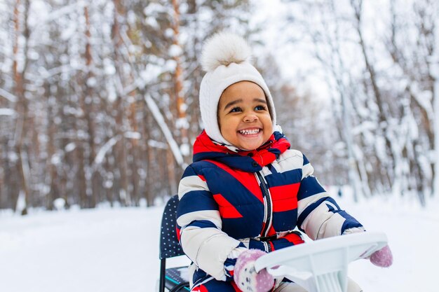 Happy little girl enjoy a sleigh ride on christmas holidays